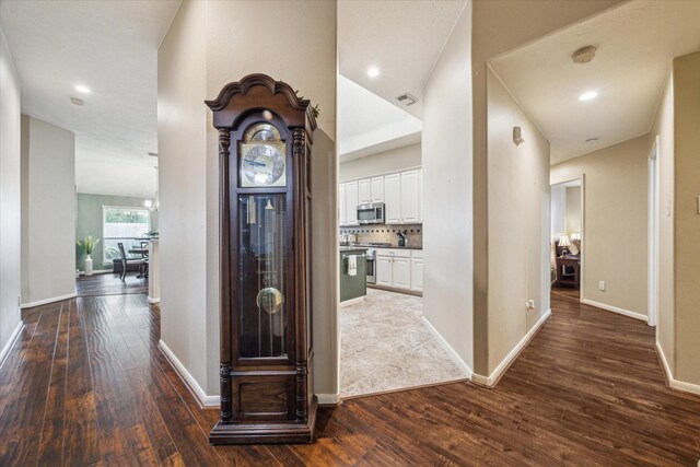 corridor with recessed lighting, baseboards, and dark wood-style floors