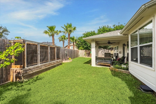 view of yard featuring a ceiling fan and a fenced backyard