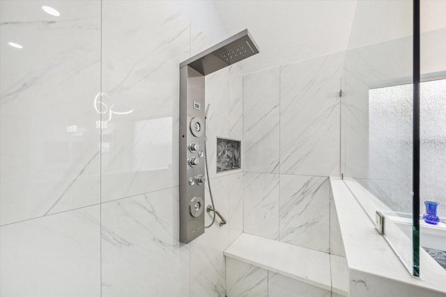 bathroom with a marble finish shower