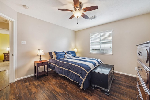 bedroom featuring visible vents, a ceiling fan, dark wood finished floors, and baseboards