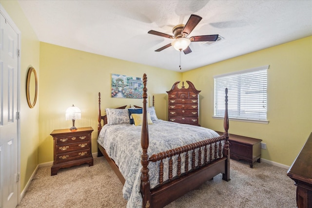 carpeted bedroom featuring baseboards, ceiling fan, and visible vents