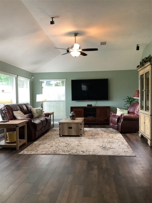 living area with visible vents, ceiling fan, lofted ceiling, and dark wood-style floors