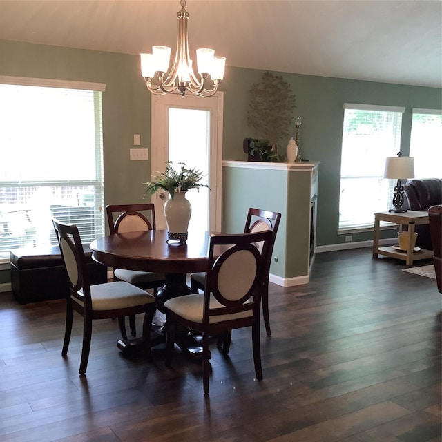 dining room featuring baseboards, dark wood-style flooring, and a chandelier