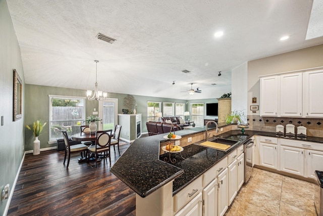 kitchen featuring recessed lighting, visible vents, a wealth of natural light, and a sink