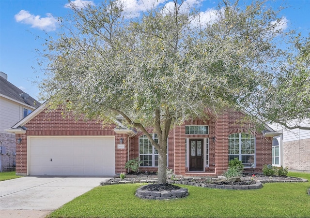 view of front of house with brick siding, a garage, a front lawn, and driveway