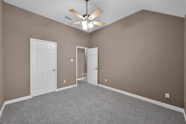 unfurnished bedroom featuring visible vents, baseboards, ceiling fan, carpet flooring, and vaulted ceiling