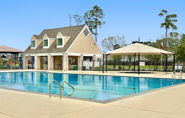 pool featuring fence and a patio area