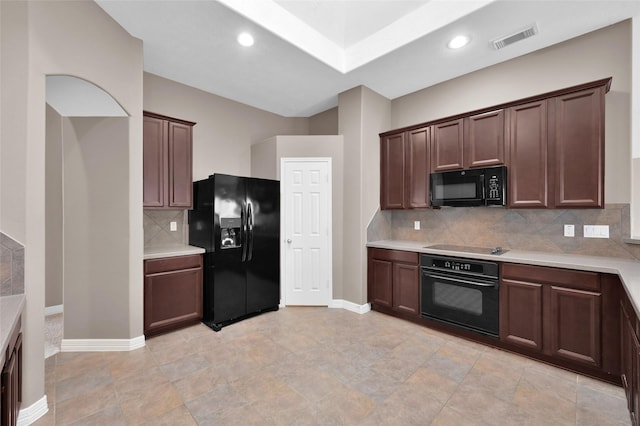 kitchen with light countertops, baseboards, black appliances, and visible vents