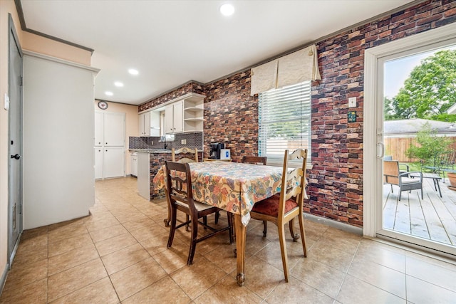 dining room featuring recessed lighting, light tile patterned floors, and brick wall