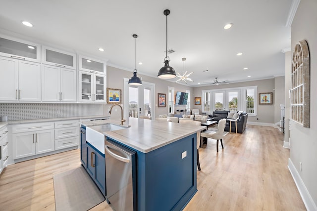 4014 Miramar Ct, Galveston, TX 77554 - kitchen featuring stainless steel dishwasher, a sink, crown molding, and blue cabinets