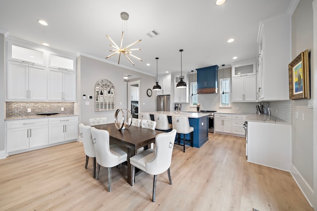 4014 Miramar Ct, Galveston, TX 77554 - dining room featuring crown molding, recessed lighting, washer / dryer, and light wood finished floors