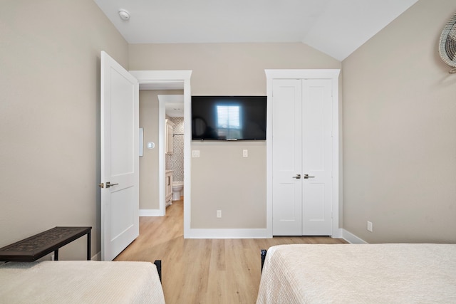 4014 Miramar Ct, Galveston, TX 77554 - bedroom featuring baseboards, lofted ceiling, light wood finished floors, and a closet