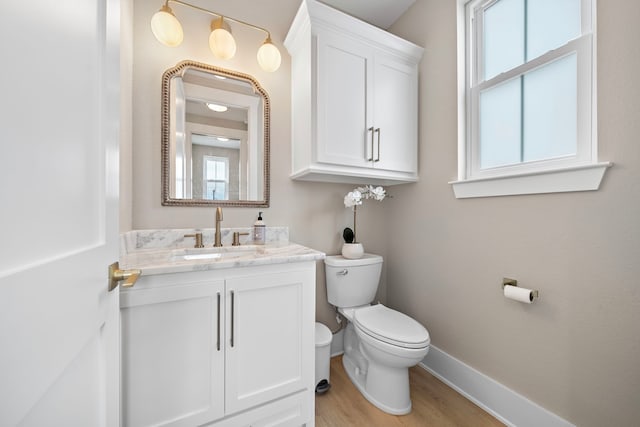 4014 Miramar Ct, Galveston, TX 77554 - bathroom with baseboards, vanity, toilet, and wood finished floors