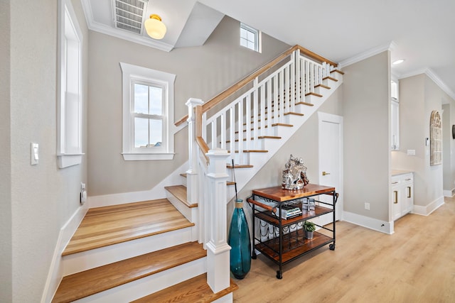 4014 Miramar Ct, Galveston, TX 77554 - stairway featuring crown molding, baseboards, and wood finished floors