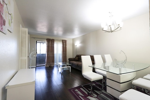 dining area with an inviting chandelier and hardwood / wood-style floors