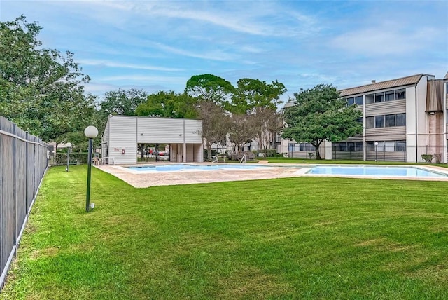 pool with fence and a yard