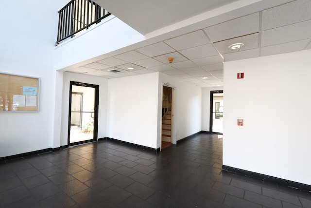 unfurnished room with baseboards, recessed lighting, stairs, and dark tile patterned flooring