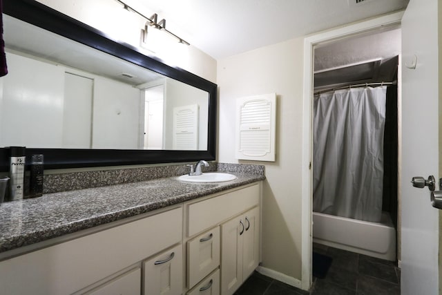 bathroom with shower / bath combo with shower curtain, tile patterned floors, baseboards, and vanity