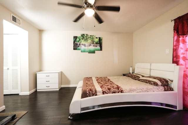 bedroom featuring baseboards, ceiling fan, wood finished floors, and visible vents