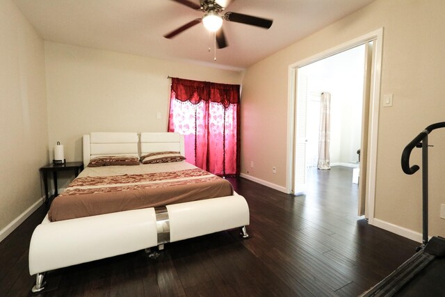 bedroom with baseboards, a ceiling fan, and dark wood-style flooring