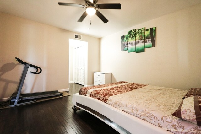 bedroom with ceiling fan, visible vents, and dark wood finished floors