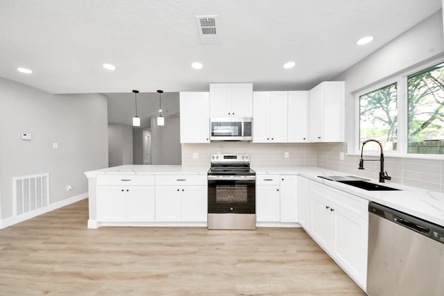 16315 Summer Dew Ln, Houston, TX 77095 - kitchen featuring stainless steel appliances, a sink, backsplash, light wood-type flooring, and recessed lighting