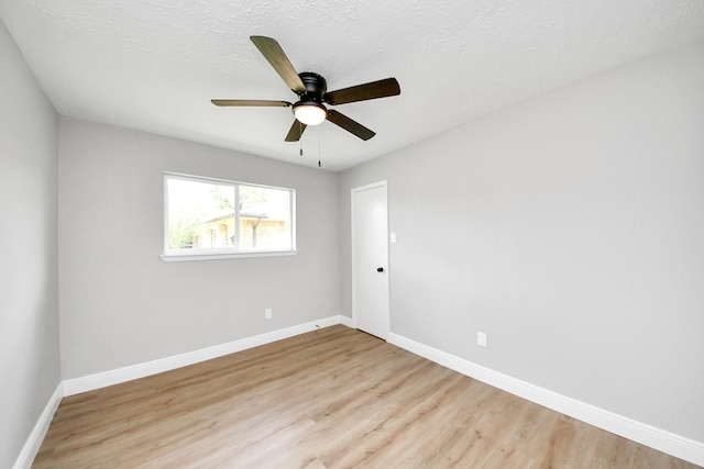 16315 Summer Dew Ln, Houston, TX 77095 - spare room featuring light wood finished floors, baseboards, ceiling fan, and a textured ceiling