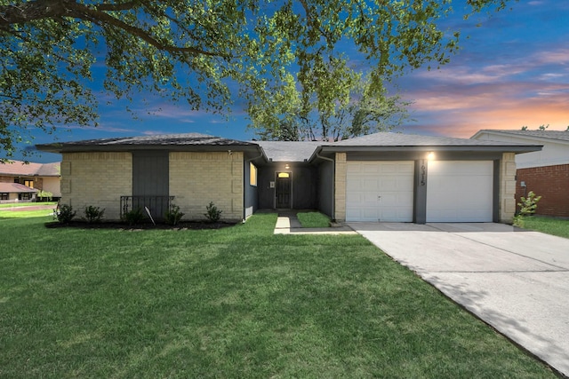16315 Summer Dew Ln, Houston, TX 77095 - view of front of home featuring a garage, concrete driveway, a yard, and brick siding
