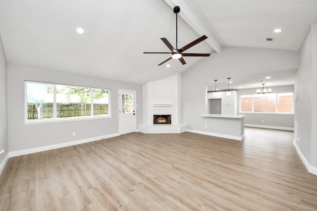 16315 Summer Dew Ln, Houston, TX 77095 - unfurnished living room featuring light wood-style flooring, plenty of natural light, a ceiling fan, a brick fireplace, and recessed lighting