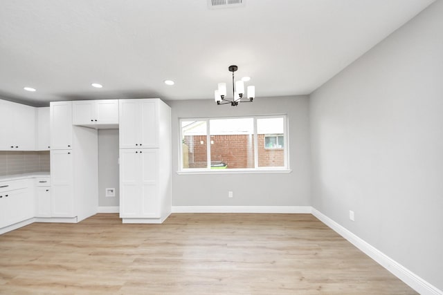 16315 Summer Dew Ln, Houston, TX 77095 - unfurnished dining area featuring a chandelier, light wood finished floors, baseboards, and recessed lighting