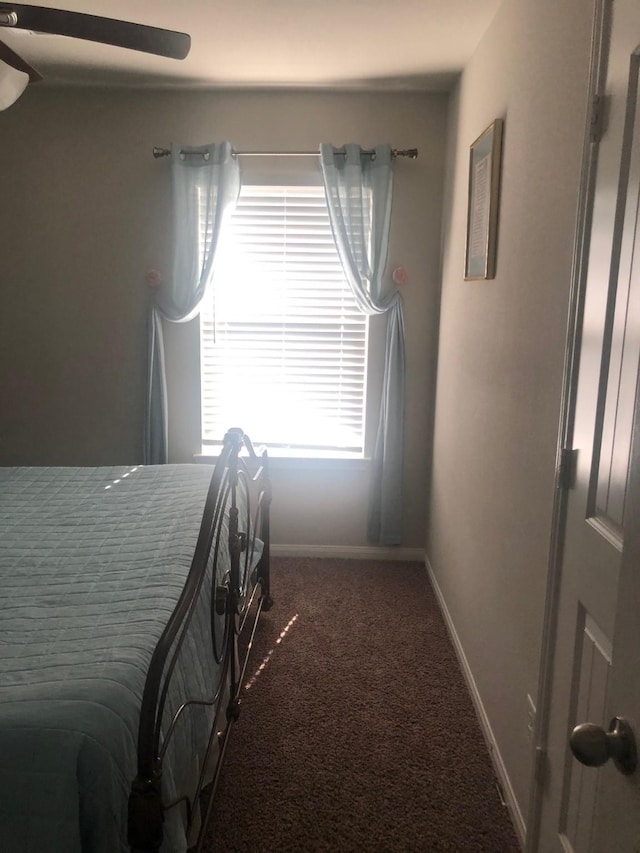 carpeted bedroom with baseboards and a ceiling fan