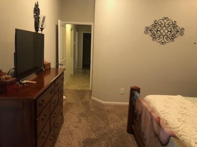 bedroom featuring baseboards and carpet
