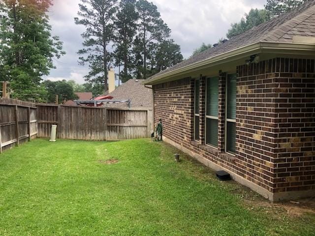view of yard with a fenced backyard