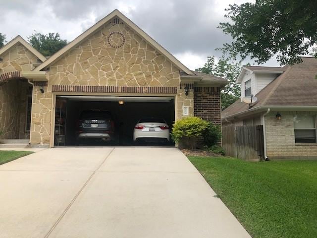 view of front of property with a front yard, stone siding, brick siding, concrete driveway, and an attached garage
