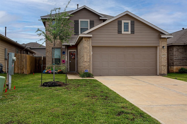 traditional-style house featuring a garage, fence, a front yard, brick siding, and concrete driveway