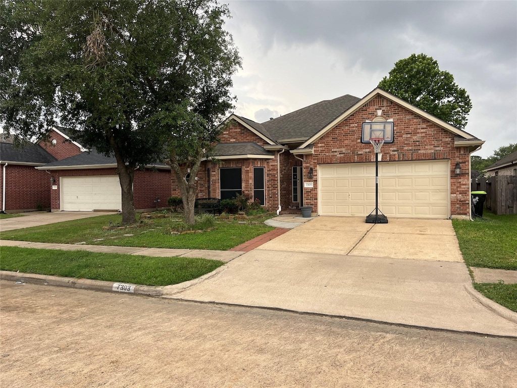 7303 April Creek Ln, Houston, TX 77095 - traditional-style house featuring concrete driveway, brick siding, an attached garage, and a front yard