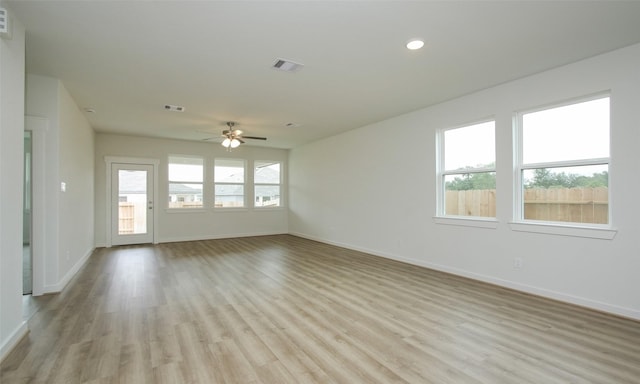 4439 Azalea Blossom Rd, Pinehurst, TX 77362 - unfurnished living room with visible vents, light wood-style flooring, baseboards, and ceiling fan