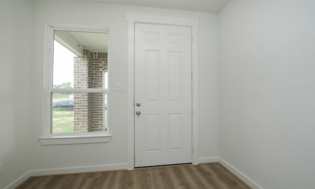 4439 Azalea Blossom Rd, Pinehurst, TX 77362 - doorway to outside with baseboards and wood finished floors