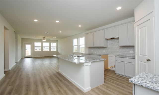 4439 Azalea Blossom Rd, Pinehurst, TX 77362 - kitchen featuring recessed lighting, a sink, light wood finished floors, and backsplash