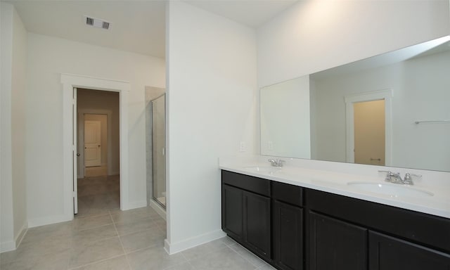 4439 Azalea Blossom Rd, Pinehurst, TX 77362 - bathroom featuring visible vents, a sink, tile patterned flooring, and a stall shower