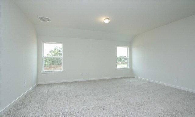 4439 Azalea Blossom Rd, Pinehurst, TX 77362 - unfurnished room featuring visible vents, baseboards, lofted ceiling, and light colored carpet