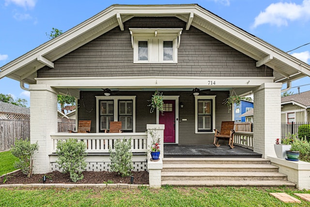 view of front of house featuring covered porch, fence, and a ceiling fan