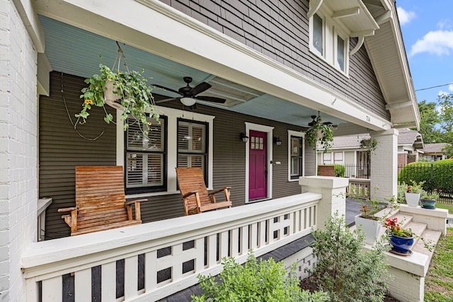 view of exterior entry featuring covered porch and ceiling fan