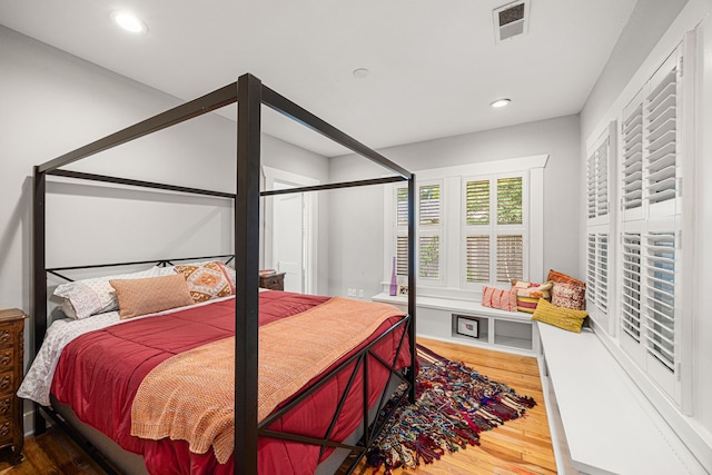 bedroom with recessed lighting, wood finished floors, and visible vents