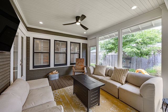 sunroom featuring ceiling fan and an outdoor living space