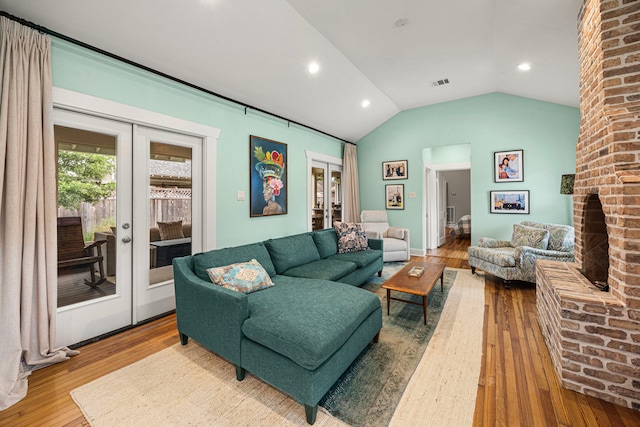 living room featuring french doors, visible vents, lofted ceiling, recessed lighting, and hardwood / wood-style floors