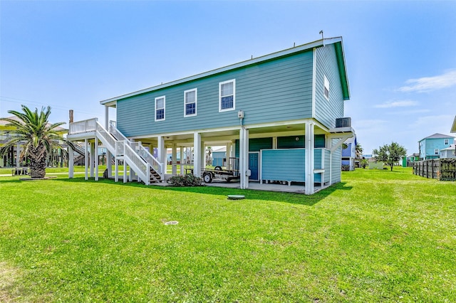 back of house with a yard and stairs