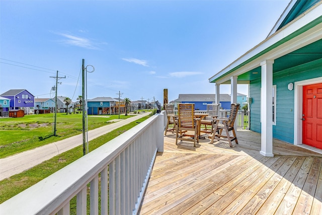 deck featuring a residential view and a lawn