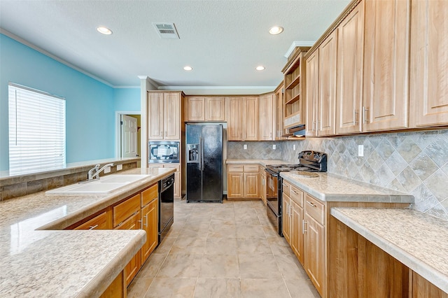 kitchen with visible vents, light countertops, a sink, backsplash, and black appliances