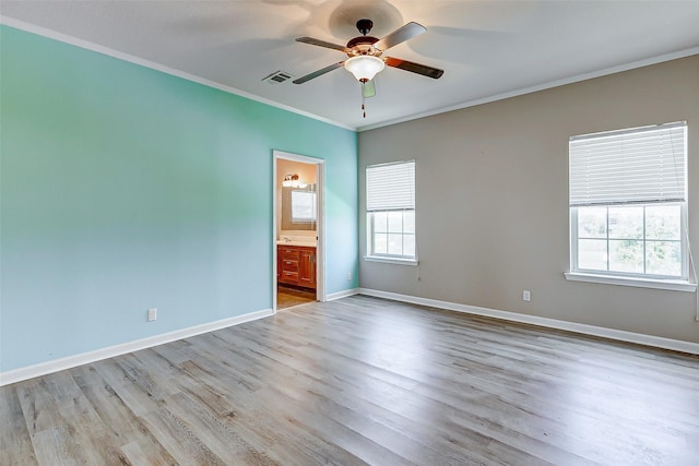 unfurnished room with ceiling fan, visible vents, wood finished floors, baseboards, and ornamental molding